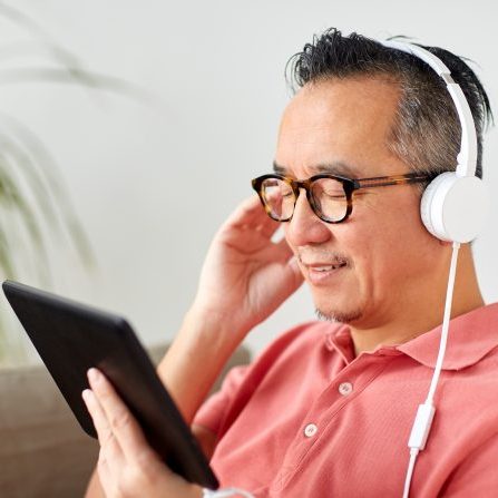 man with tablet pc and headphones at home
